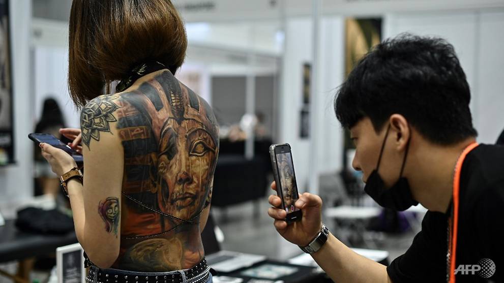 Malaysia slams tattoo expo as porn over half-naked pics 
